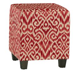 a red and white ottoman sitting on top of a wooden leg stool with an ornate pattern