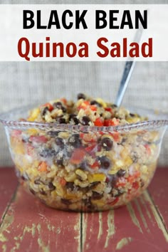 black bean quinoa salad in a glass bowl on a red wooden table with text overlay