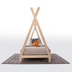 a bed with a wooden frame on top of it and a stuffed animal in the middle