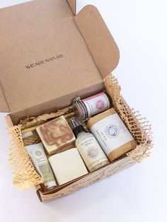 an open box with soaps and lotions in it