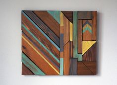 a piece of wood that has been made to look like an abstract painting on the wall