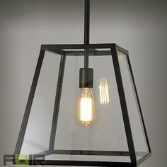 a light fixture with two bulbs hanging from it's center and one bulb turned on