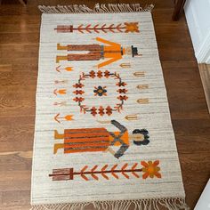 an orange and white rug with arrows on it