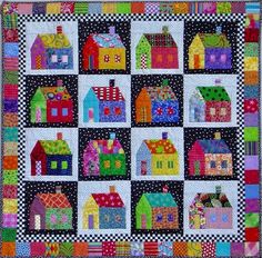 a colorful quilt with houses on it