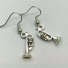 two silver tone musical instruments dangling earrings