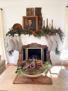 a mantel with stockings and pine cones on it