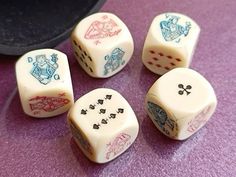 six dice with different designs on them sitting on a table