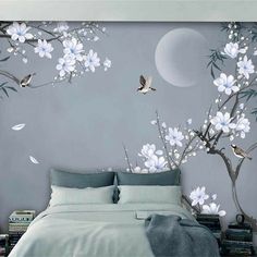 a bedroom with white flowers and birds on the wall