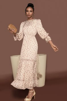 This maxi dress is crafted with luxe lurex threads, long flounce sleeves and a subtle beige and tan floral pattern. Its statement-making ruffles offer a graceful and romantic silhouette, perfect for special occasions. Features a round neckline and a hidden zipper in the back for closure. Simple Modest Outfits, Making Ruffles, Harvey Outfits, Romantic Silhouette, Conservative Outfits, Neutral Dress, Modest Maxi Dress, Lurex Dress, Modest Summer Dresses