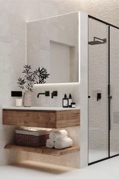 a bathroom with a sink, mirror and shower stall