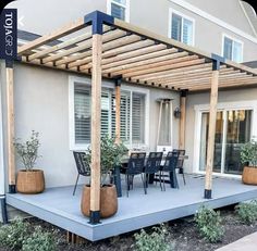 an outdoor patio with chairs and tables under a pergolated trellis on the deck