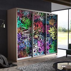 a room that has some kind of graffiti on the wall behind glass doors in it