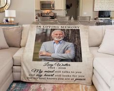 a couch with a blanket on it that has an image of a man in a suit