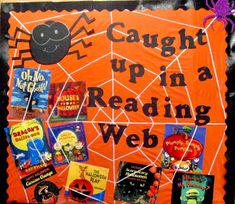 an orange bulletin board with halloween books on it and spider webs around the edges