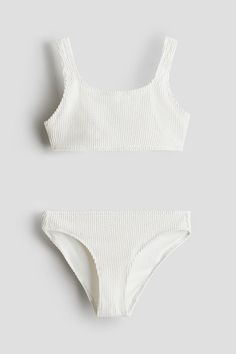 Textured swimsuit top and matching briefs. Top with wide shoulder straps  a square neckline  and a plastic fastener at back. Fully lined. Bathing Suits Teen, Textured Swimsuit, Vacation Packing, Cute Bathing Suits, White Swimsuit, Maternity Swimwear, Cardigan Sweater Jacket, Cute Swimsuits