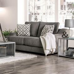 a living room scene with focus on the couch and coffee table in the centerpiece