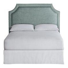 an upholstered bed with white linens and pillows on the headboard, isolated against a white background