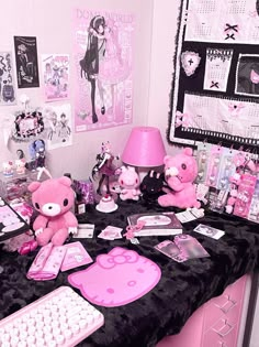 a desk topped with lots of pink stuff animals and other items on top of it