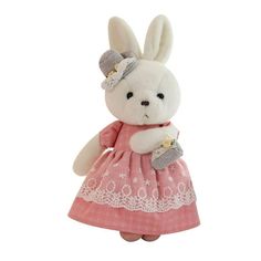 a white stuffed rabbit wearing a pink dress