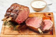 Angled view of prime rib resting on a wooden cutting board, first two slices are cut and theres a bowl of horseradish cream sauce behind it. Poor Man Stew, Christmas Dinner Main Course, 50th Birthday Messages, Christmas Main Course, Prime Rib Recipes, Oven Roast Beef, Pecan Pie Recipes, French Beef Stew, Dutch Oven Beef