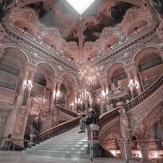 an ornate building with chandeliers and stairs