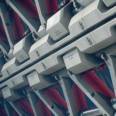 several metal lockers with red and blue curtains on them