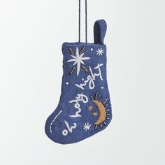 a blue christmas stocking hanging from a string with stars and moon designs on it