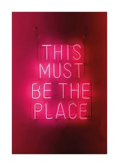 a neon sign that says, this must be the place