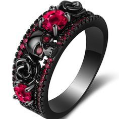 a black ring with skulls and roses on it