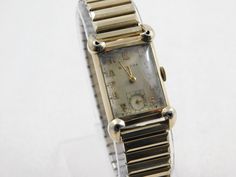 Vintage Collectible Bulova 21 Jewel Art Deco Tank Style Watch. Movement is a 7AK which dates it to 1936 and has been completely serviced, cleaned, oiled and running great. Great Style from the 1930's. Glass Crystal is, I believe the original one and although it has scratches on it, is still in nice condition. The band is a nice Spiedel band from the same era. I can change out to a leather band if you would like. Case size is 21mm x 37 mm. I believe the open holes in each corner are hearts that w Mens Gold Chain Necklace, Jewel Art, Men Jewellery, Gold Chains For Men, Small Jewelry Box, Style Watch, Jewelry Lookbook, Mens Gold, Small Jewelry