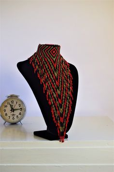 Unique African Maasai Handcrafted Beaded Necklace with an Elegant Look and Brilliant Finish. Color - Red, Black and Golden Brown. Size - Adjustable Width. Fringe Length - 11 Inches / 28 cm. **GET FREE SHIPPING FOR ADDITIONAL ITEMS PURCHASED. Yes, Buy Multiple Items and pay shipping for 1 item only- The rest ships Free. (No Limits on the number of Multiple items). With a faster delivery time of 3 days via DHLExpress, Worldwide. Ordinary/Standard Shipping also available upon request. We Custom Mak African Beads Necklace, Unique Statement Necklace, Woman Necklace, Style Africain, Handmade Beaded Necklace, African Necklace, Handmade Beaded Necklaces, Necklace Chunky, Maasai