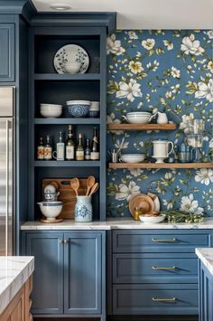 a kitchen with blue cabinets and floral wallpaper