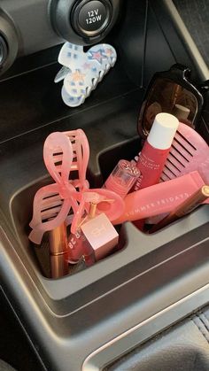 the inside of a car with cosmetics and other items in it's trays