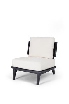 a black and white chair with a pillow on it's back end, against a white background