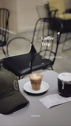 a cap sitting on top of a table next to a cup of coffee