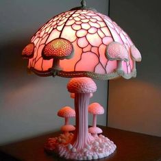 a pink lamp sitting on top of a wooden table