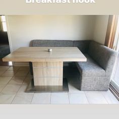 a couch and table in a room with white tile flooring that has the words breakfast hook on it