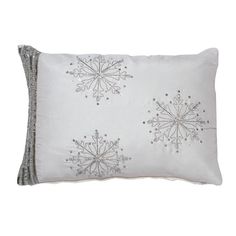 a white pillow with silver snowflakes on the front and back, sitting on a white background