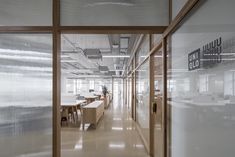 an office building with glass walls and wooden accents