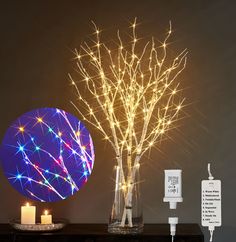 a table topped with a vase filled with flowers and candles next to a blue ball