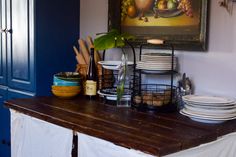 a kitchen counter with plates and bowls on it