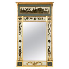 a mirror with an ornate design on the top and bottom part, in gold leaf trimming