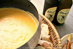 two bottles of beer and some food on a table