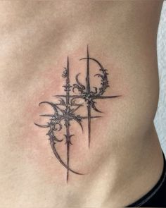 a tattoo on the side of a woman's stomach with an arrow and vines