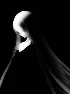 a woman with long hair in the dark