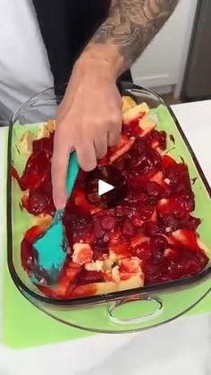 a man is spreading fruit into a casserole dish