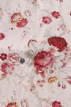 the fabric has red and white flowers on it