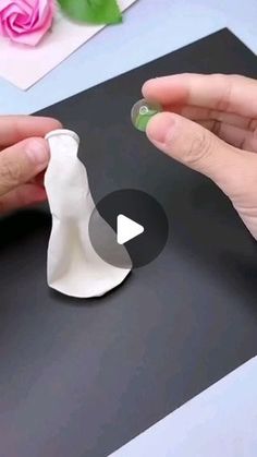 someone is making a paper sculpture with their hands