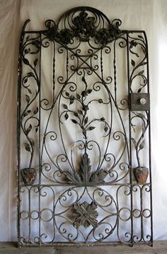 an iron wall hanging with flowers on it