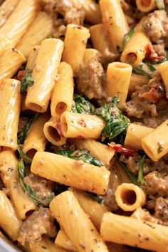 pasta with sausage and spinach in a pan